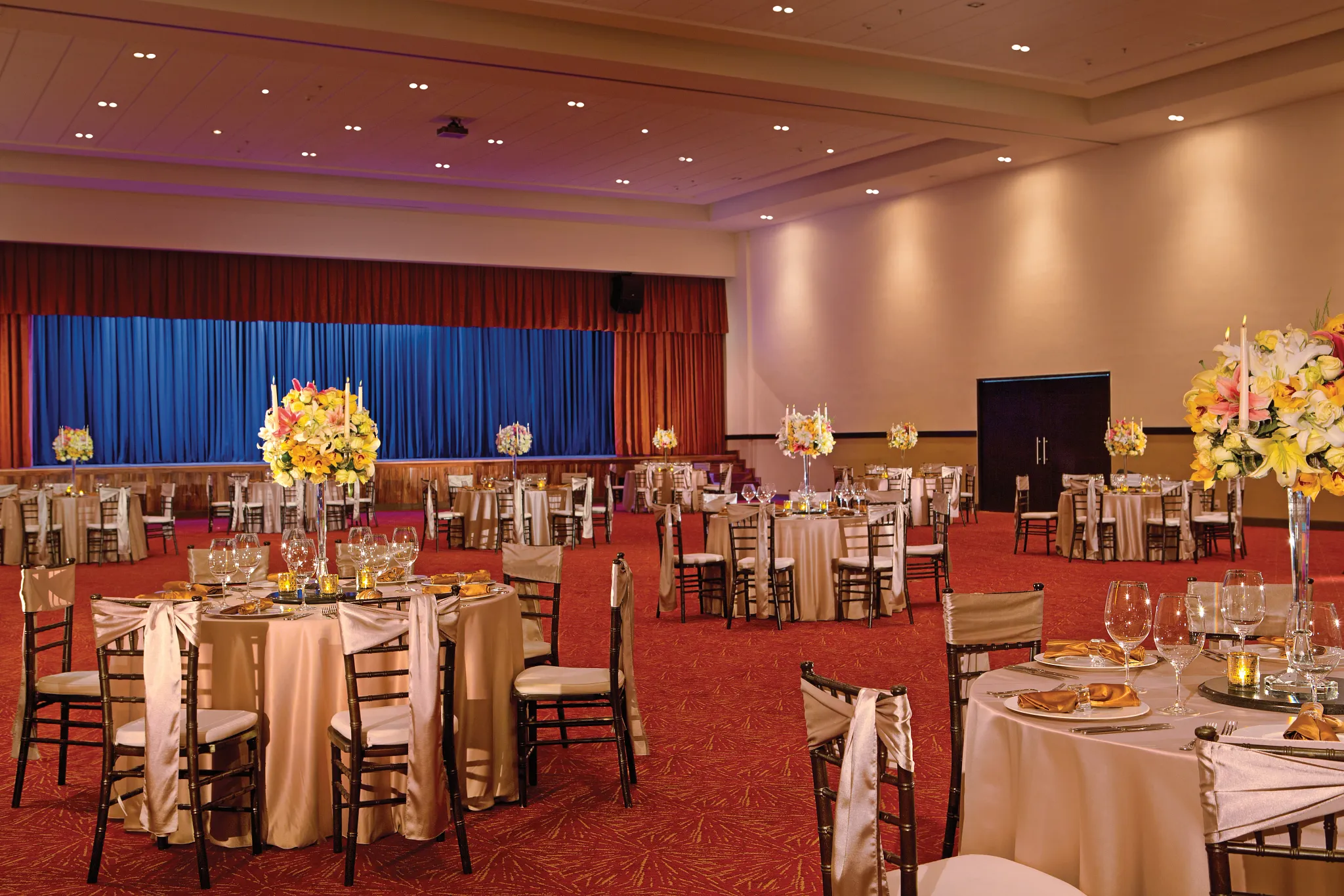 Elegant indoor ballroom reception with round tables and floral centerpieces at Secrets Vallarta Bay Puerto Vallarta