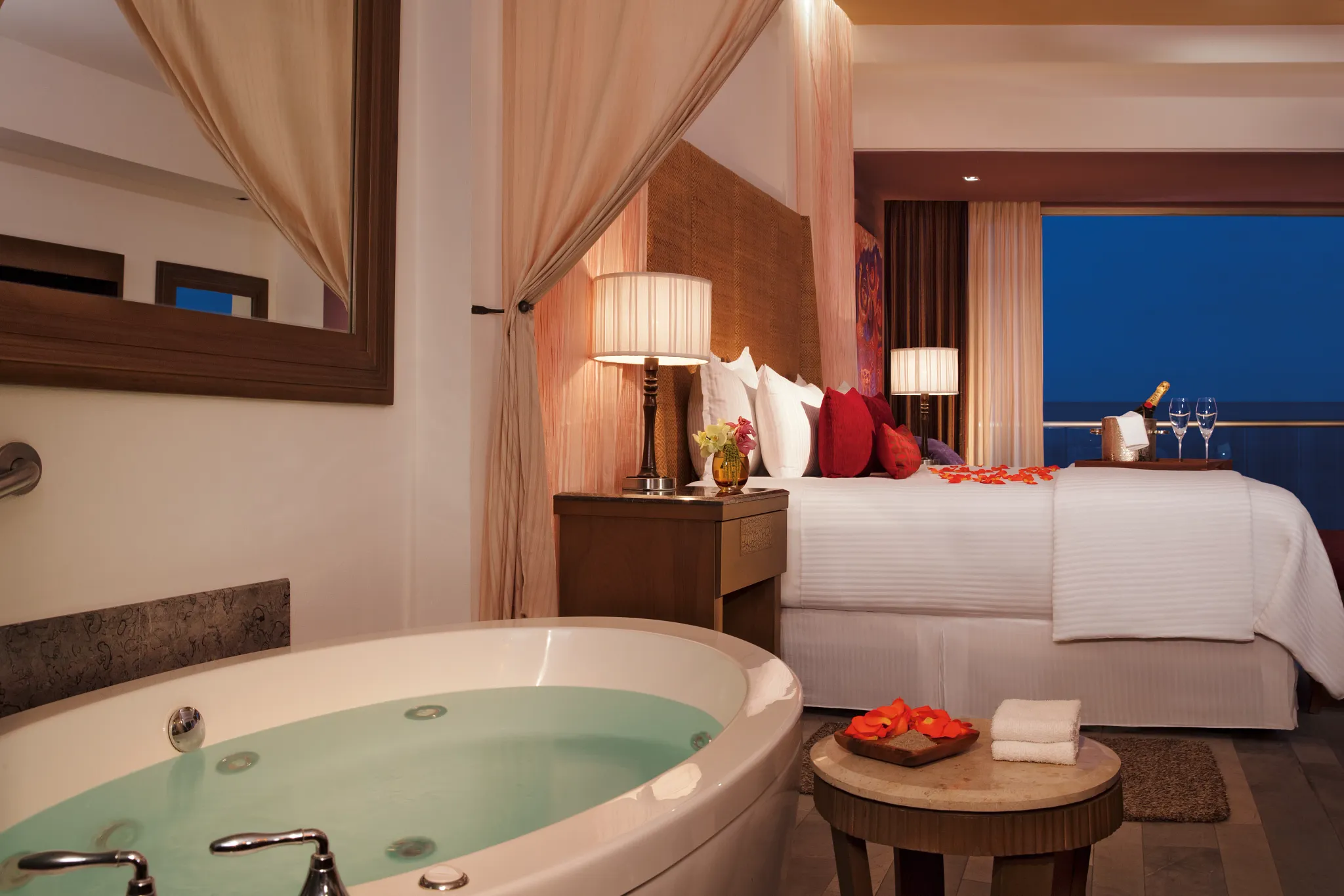 Romantic Junior Suite Ocean View with in-room soaking tub, rose petals, and ocean view balcony at Secrets Vallarta Bay.