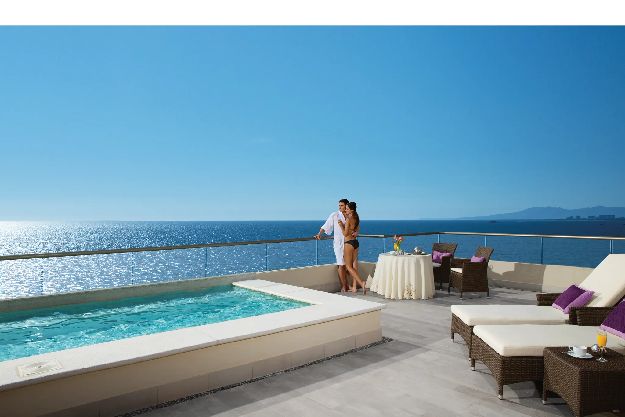 Couple enjoying Presidential Suite oceanfront terrace with plunge pool at Secrets Vallarta Bay Puerto Vallarta.