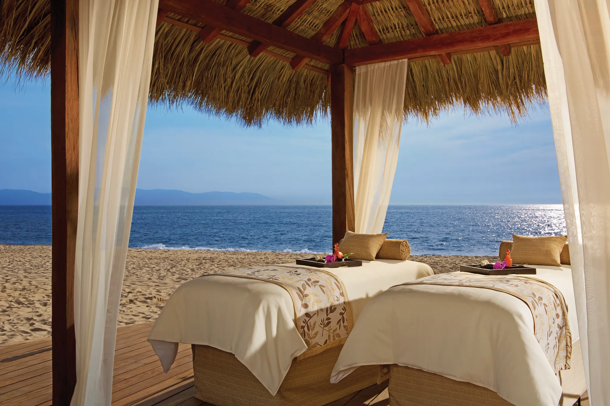 Twin massage beds in a beach cabana overlooking the ocean at Secrets Vallarta Bay Puerto Vallarta.