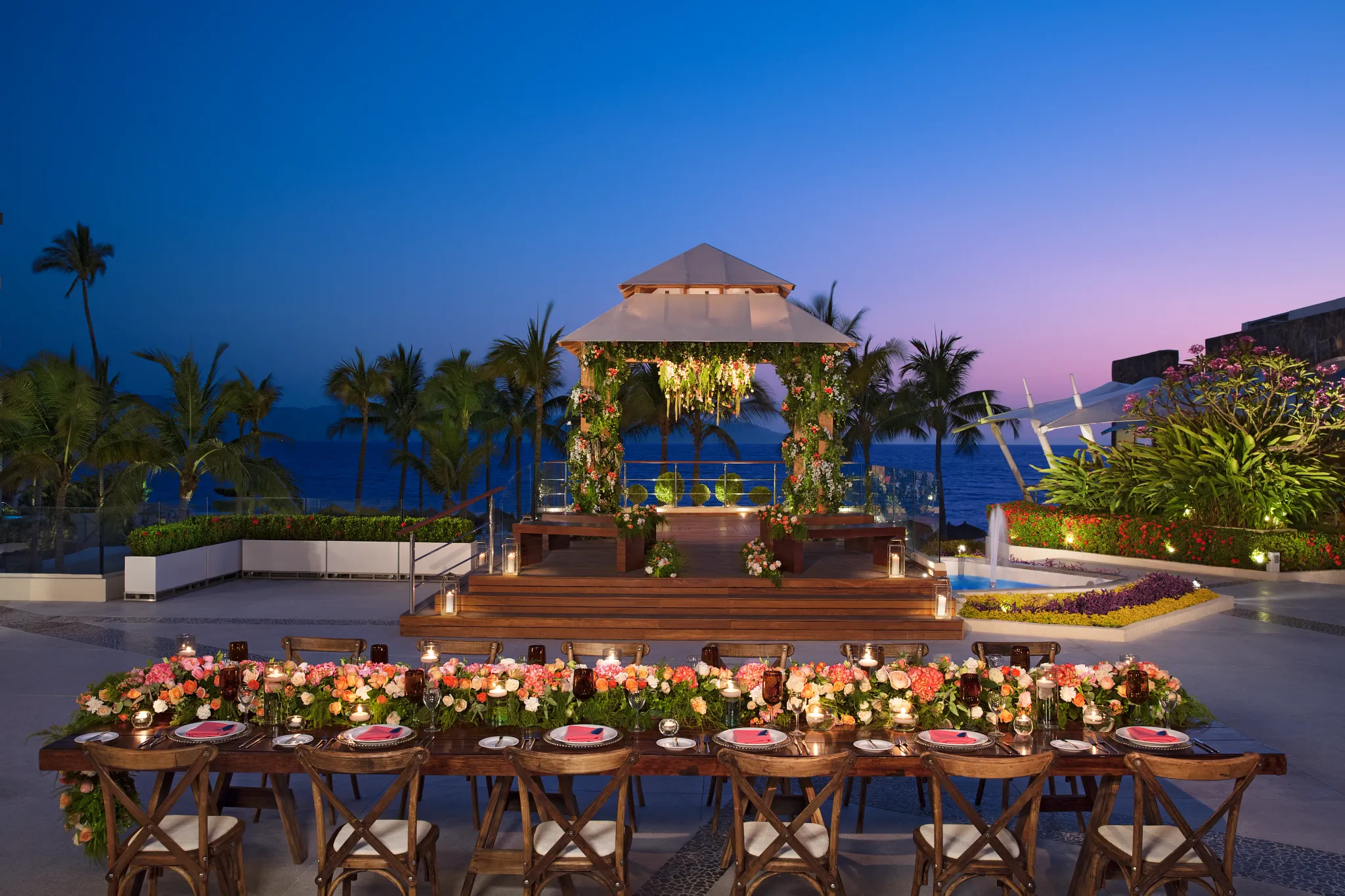 Evening reception setup with gazebo and long table at Vista Terrace at Secrets Vallarta Bay Puerto Vallarta